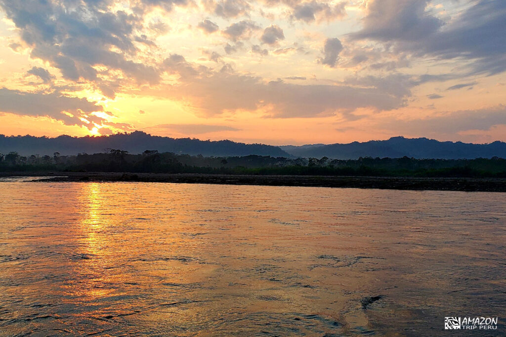 Sunset over the river in Manu